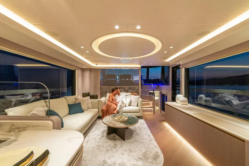  Yacht Photos Pics Luxurious interior of 2026 Absolute NAVETTA 70 yacht with elegant seating and ambient lighting.