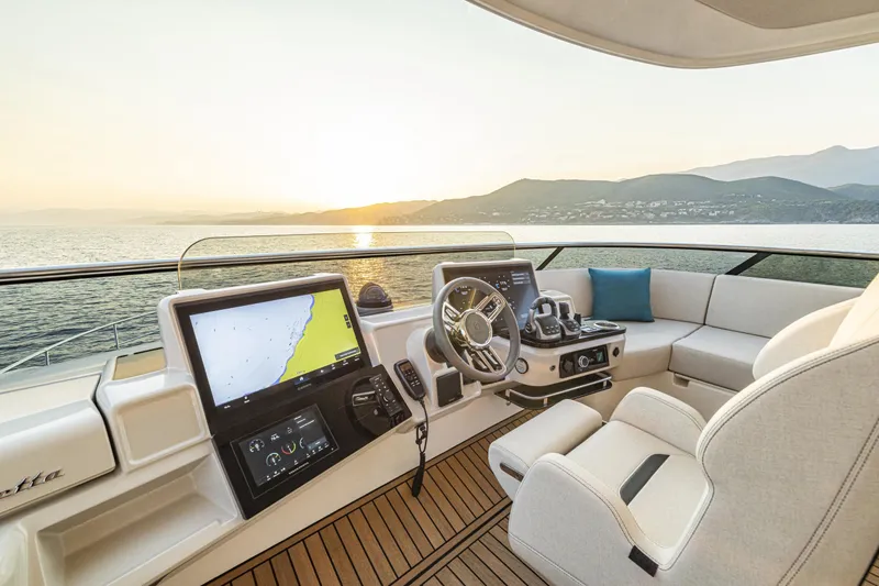  Yacht Photos Pics Luxurious 2026 Absolute NAVETTA 70 yacht cockpit with modern navigation system at sunset.