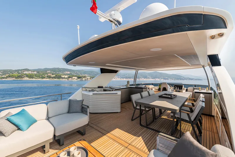  Yacht Photos Pics Luxurious 2026 Absolute NAVETTA 70 yacht deck with elegant seating and dining area.