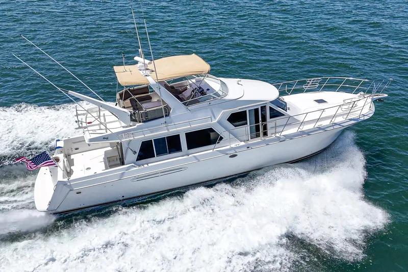 Freedom Rocks Yacht Photos Pics 2004 Navigator Rival 57 yacht cruising on open water, showcasing sleek design and luxury features.