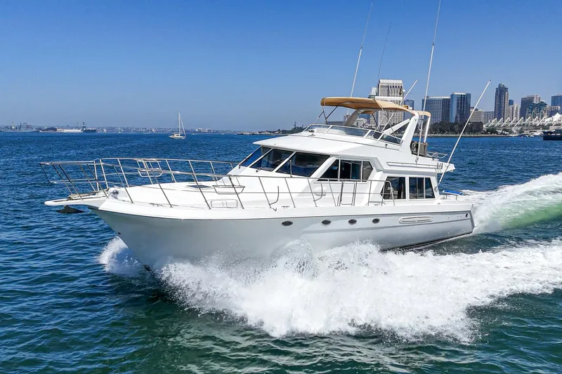 Freedom Rocks Yacht Photos Pics 2004 Navigator Rival 57 yacht cruising on open water near city skyline.