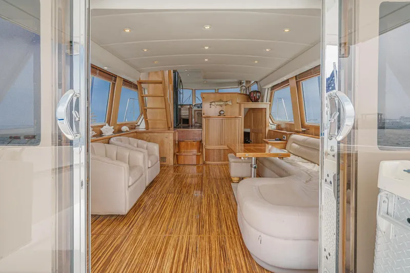 Freedom Rocks Yacht Photos Pics Luxurious interior of 2004 Navigator Rival 57 yacht with elegant wood flooring and plush seating.