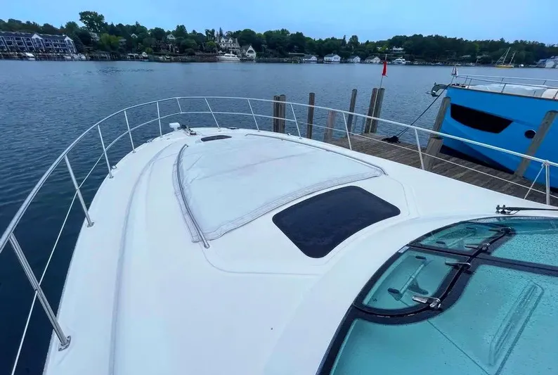 Down Time Yacht Photos Pics 2010 Sea Ray 500 Sundancer yacht docked by a serene waterfront.