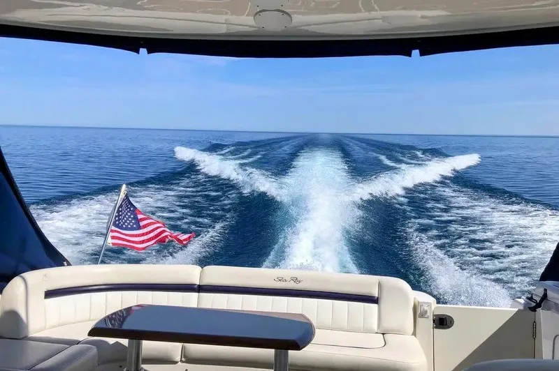 Down Time Yacht Photos Pics Sea Ray 500 Sundancer 2010 cruising with American flag, ocean view from yacht deck.