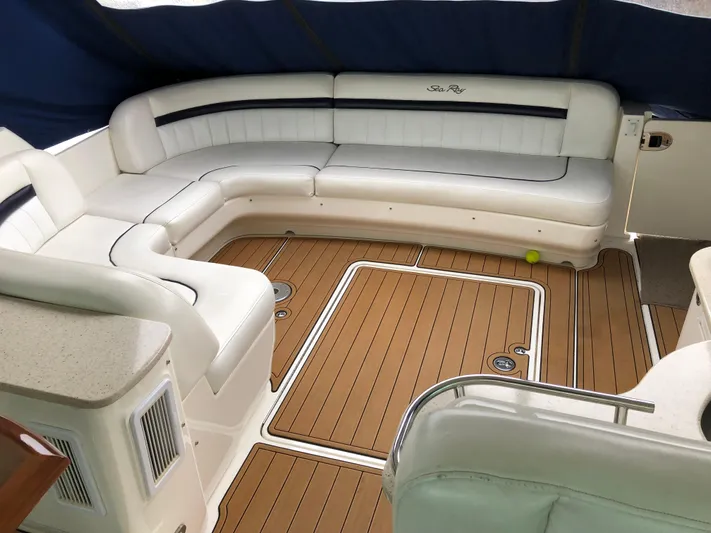 Down Time Yacht Photos Pics Luxurious interior of 2010 Sea Ray 500 Sundancer yacht with white seating and wood flooring.