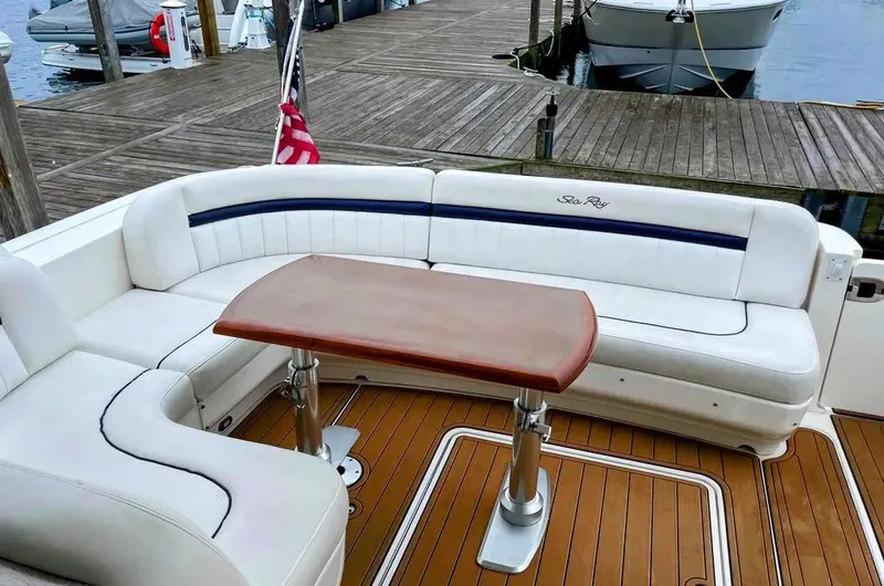 Down Time Yacht Photos Pics 2010 Sea Ray 500 Sundancer yacht with white seating and wooden table on deck.