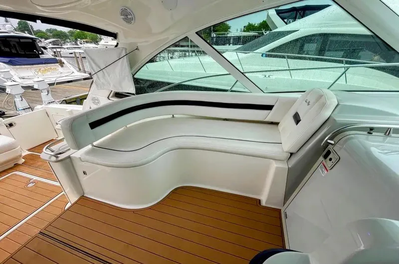 Down Time Yacht Photos Pics Luxurious interior of 2010 Sea Ray 500 Sundancer yacht with sleek seating and wooden flooring.