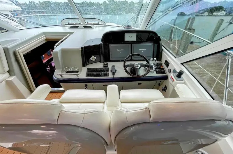 Down Time Yacht Photos Pics Interior helm of 2010 Sea Ray 500 Sundancer yacht with dual screens and leather seating.
