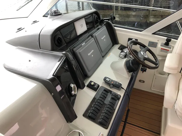 Down Time Yacht Photos Pics Cockpit of 2010 Sea Ray 500 Sundancer with navigation equipment and steering wheel.