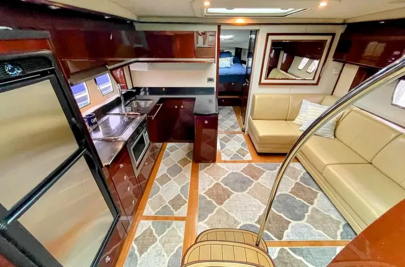 Down Time Yacht Photos Pics Interior of 2010 Sea Ray 500 Sundancer yacht with kitchen and seating area.