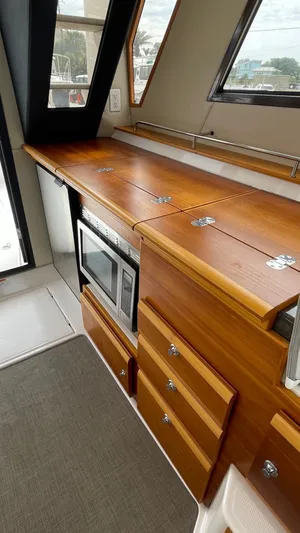  Yacht Photos Pics 2018 Cutwater C-30 Command Bridge LE interior with wood cabinetry and built-in microwave.