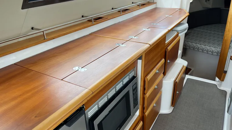  Yacht Photos Pics 2018 Cutwater C-30 Command Bridge LE interior with wooden cabinetry and modern appliances.
