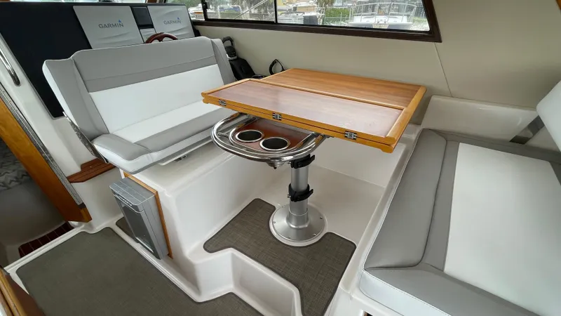  Yacht Photos Pics 2018 Cutwater C-30 Command Bridge LE interior with seating and wooden table.