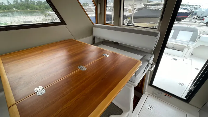  Yacht Photos Pics Interior of 2018 Cutwater C-30 Command Bridge LE with wooden table and seating.