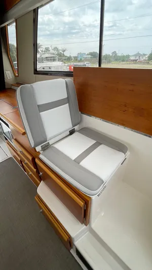  Yacht Photos Pics 2018 Cutwater C-30 Command Bridge LE interior with cushioned seating and wooden accents.