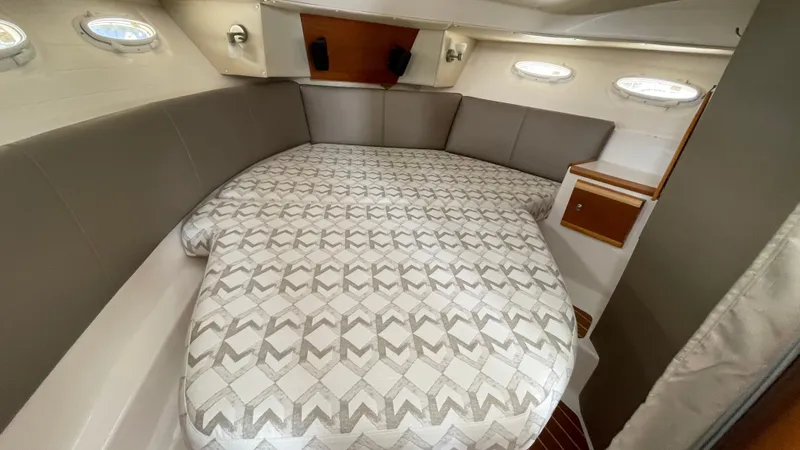  Yacht Photos Pics 2018 Cutwater C-30 Command Bridge LE cabin with patterned bedding and porthole windows.
