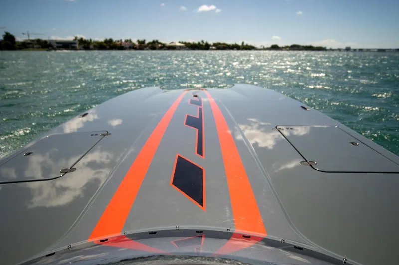  Yacht Photos Pics 2024 MTI 390X boat on water, featuring sleek design and vibrant orange stripe.