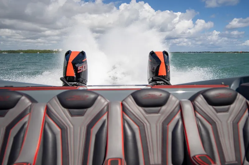  Yacht Photos Pics 2024 MTI 390X speedboat with powerful engines, cruising on open water under a cloudy sky.