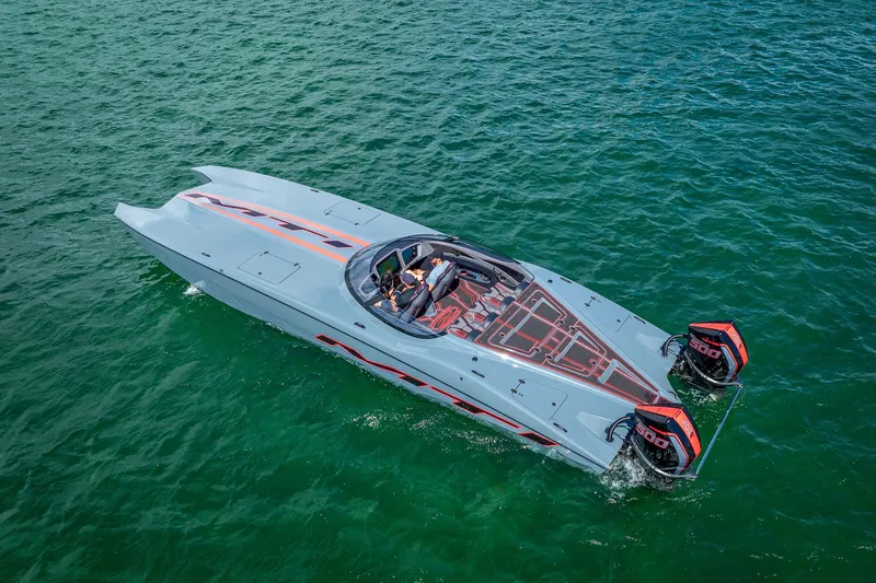  Yacht Photos Pics 2024 MTI 390X powerboat cruising on clear green water, featuring sleek design and dual engines.