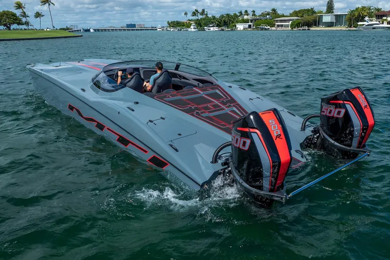  Yacht Photos Pics 2024 MTI 390X powerboat with dual Mercury 500R engines cruising on a scenic waterway.