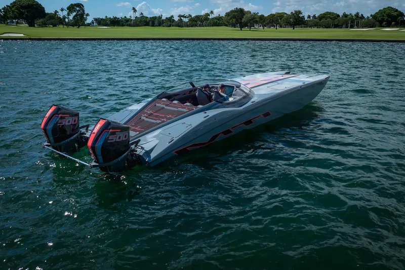  Yacht Photos Pics 2024 MTI 390X powerboat on water with dual 500 engines, scenic background.