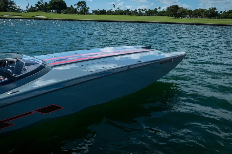  Yacht Photos Pics 2024 MTI 390X speedboat on water, sleek design, vibrant graphics, sunny day.