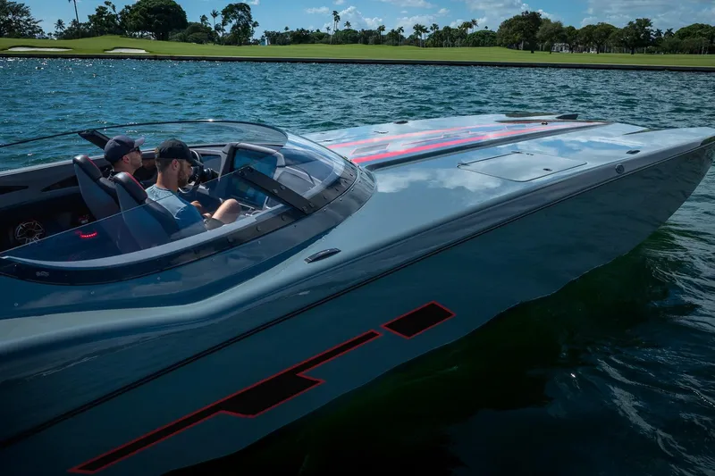  Yacht Photos Pics 2024 MTI 390X speedboat cruising on a sunny day, with two passengers onboard.