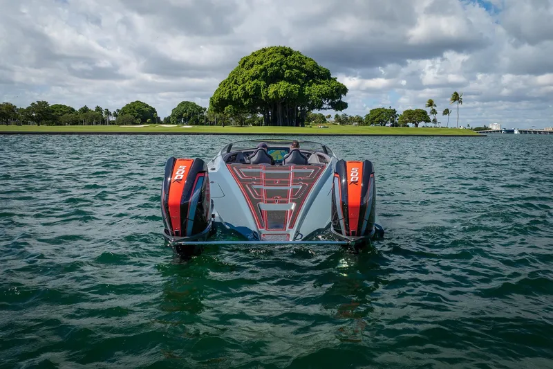  Yacht Photos Pics 2024 MTI 390X boat on water, featuring dual 500R engines, with lush island backdrop.