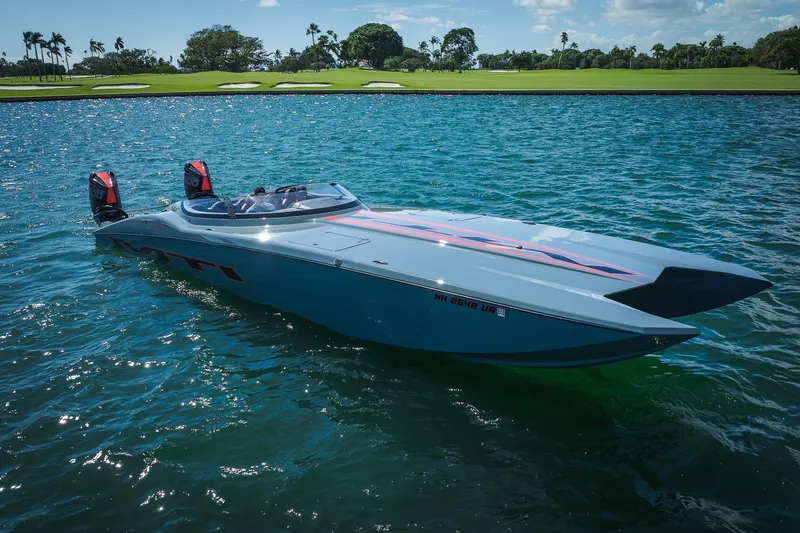  Yacht Photos Pics 2024 MTI 390X powerboat on water, sleek design, vibrant graphics, sunny day.