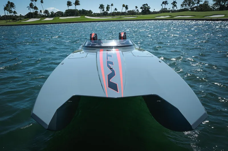  Yacht Photos Pics 2024 MTI 390X powerboat on water, sleek design, palm trees in background.