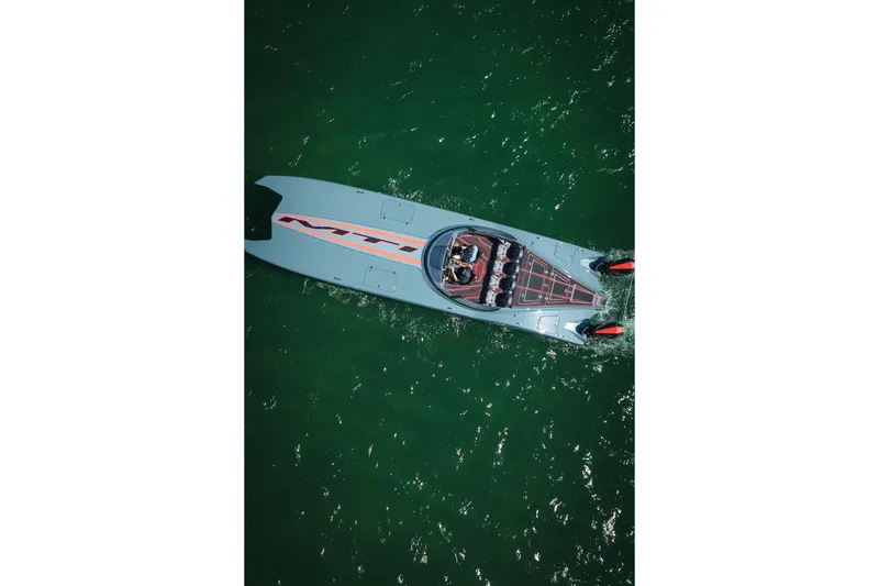  Yacht Photos Pics Aerial view of 2024 MTI 390X speedboat cruising on green water.