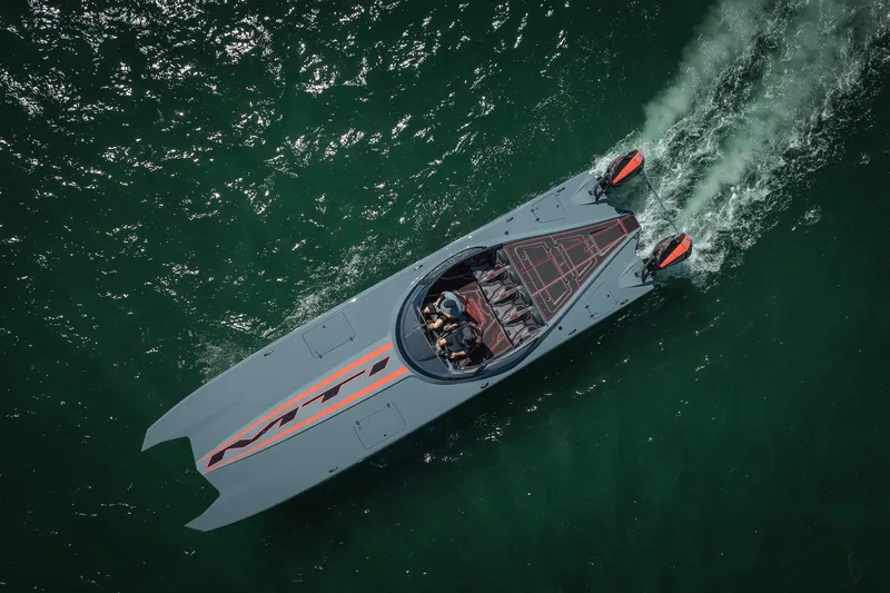  Yacht Photos Pics Aerial view of 2024 MTI 390X speedboat cruising on green water.