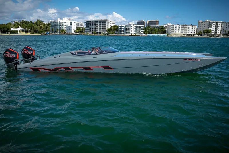  Yacht Photos Pics 2024 MTI 390X powerboat with dual 500 engines on a sunny waterfront.