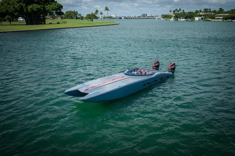  Yacht Photos Pics 2024 MTI 390X powerboat on calm water, featuring dual outboard motors.
