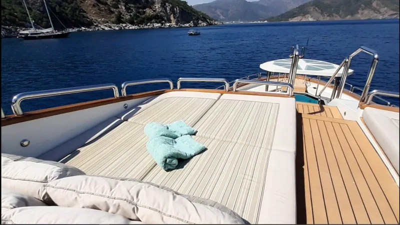 Forty Love Yacht Photos Pics Luxurious 2004 Westport Custom yacht deck with sunbathing area, overlooking serene blue waters.