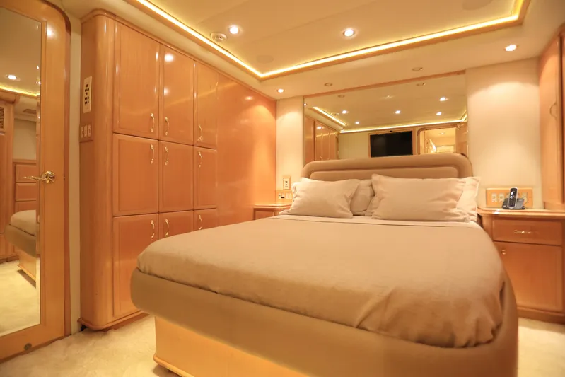 Forty Love Yacht Photos Pics Luxurious bedroom interior on a 2004 Westport Custom yacht, featuring elegant wood cabinetry.