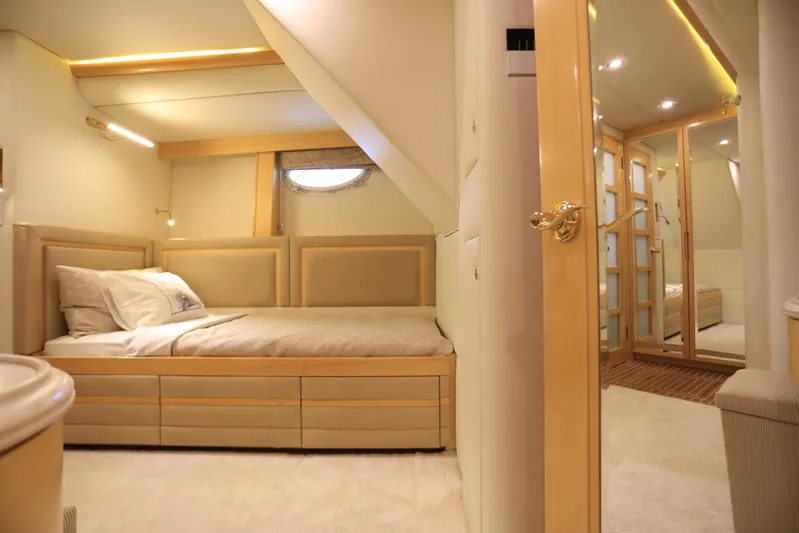 Forty Love Yacht Photos Pics Luxurious 2004 Westport Custom yacht bedroom with elegant wood finishes and cozy bedding.