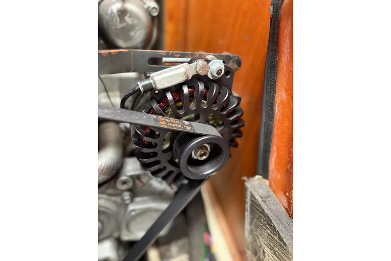  Yacht Photos Pics Close-up of a 2002 Hunter 386 engine component with belt and pulley system.