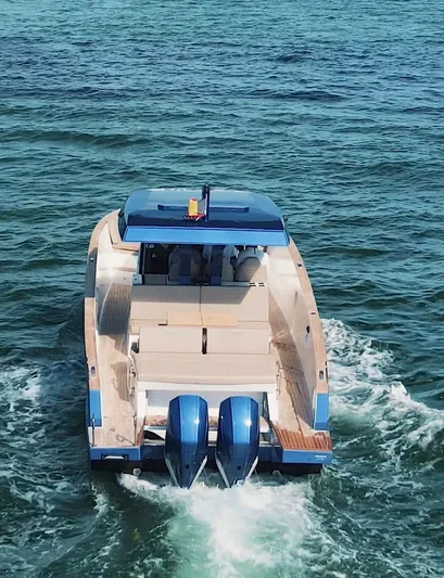 Mine Yacht Photos Pics 2022 Tesoro T38 Outboard cruising on open water, rear view.