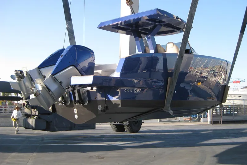 Mine Yacht Photos Pics 2022 Tesoro T38 Outboard boat suspended in a shipyard, showcasing sleek design and powerful engines.