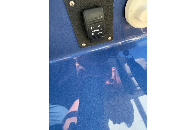 Mine Yacht Photos Pics Close-up of 2022 Tesoro T38 Outboard jackplate switch on blue surface.