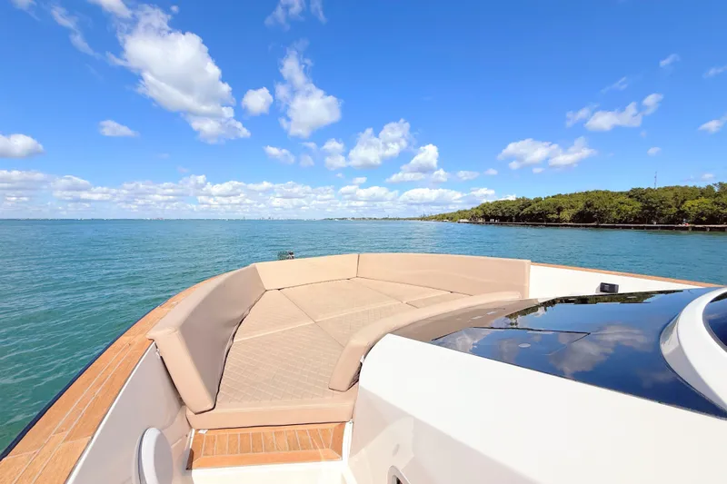 Mine Yacht Photos Pics 2022 Tesoro T38 Outboard boat with spacious deck, cruising on a sunny day.