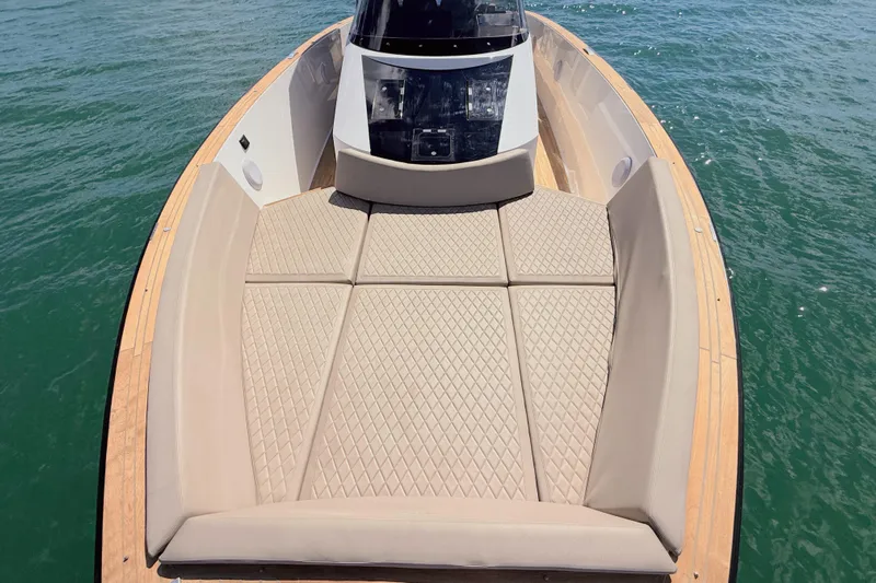 Mine Yacht Photos Pics 2022 Tesoro T38 Outboard boat with spacious sunbathing area on calm water.