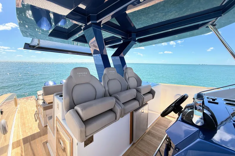 Mine Yacht Photos Pics Luxurious 2022 Tesoro T38 Outboard boat interior with plush seating and ocean view.