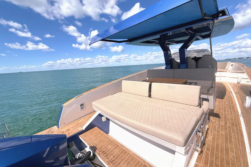 Mine Yacht Photos Pics 2022 Tesoro T38 Outboard boat with luxurious seating and canopy on open water.