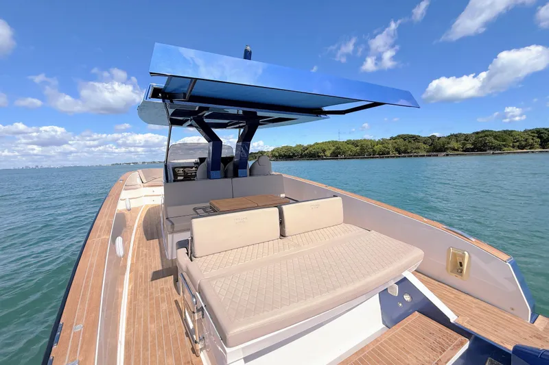 Mine Yacht Photos Pics 2022 Tesoro T38 Outboard boat with sleek design, spacious deck, and modern seating on calm waters.