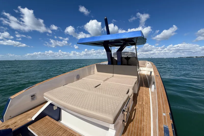 Mine Yacht Photos Pics 2022 Tesoro T38 Outboard boat on open water under a clear blue sky.
