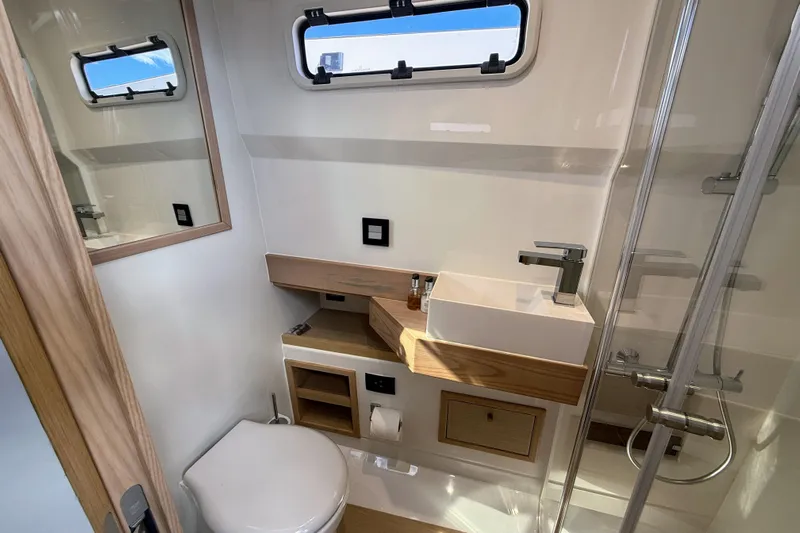 Mine Yacht Photos Pics Modern bathroom interior of 2022 Tesoro T38 Outboard boat, featuring sleek fixtures and compact design.
