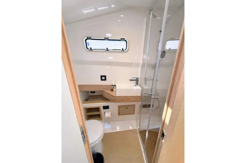 Mine Yacht Photos Pics Modern bathroom interior of 2022 Tesoro T38 Outboard boat with shower and toilet.