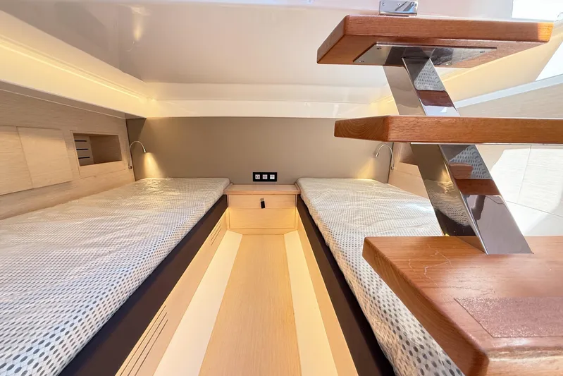Mine Yacht Photos Pics 2022 Tesoro T38 Outboard cabin interior with twin beds and modern wooden staircase.